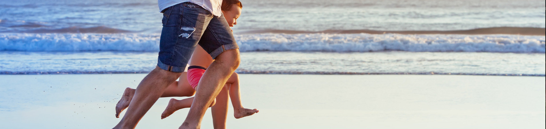 Image of Family Running on the Beach